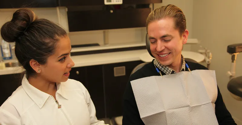 A Tremont Dental Care hygienist talking with a patient